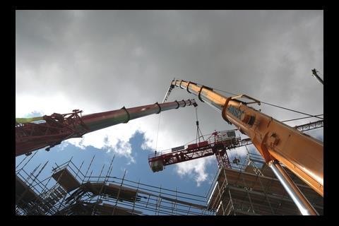Mobile cranes support the damaged structure during dismantling